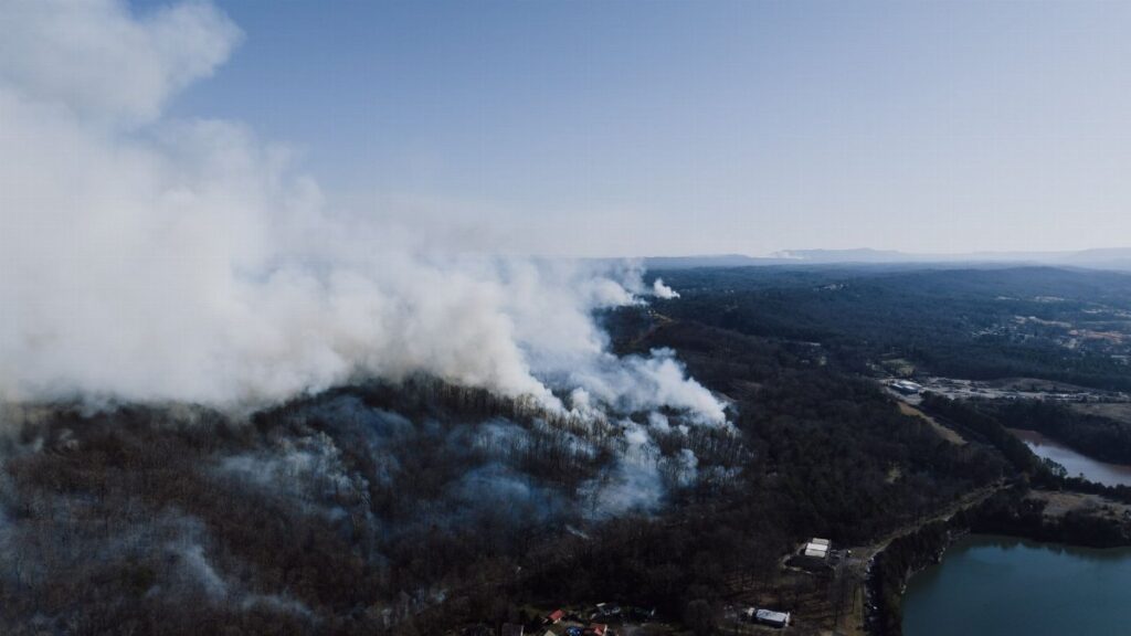 Drone view of a forest wildfire near Rossville, Georgia, USA, smoke rising.
