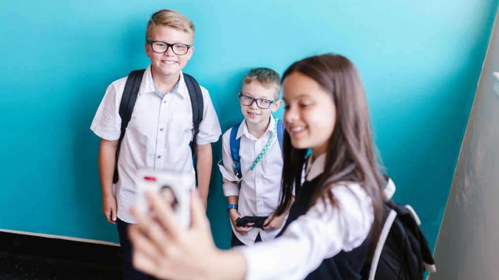 Group of happy students posing for a selfie on their first day back to school.