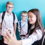 Group of happy students posing for a selfie on their first day back to school.