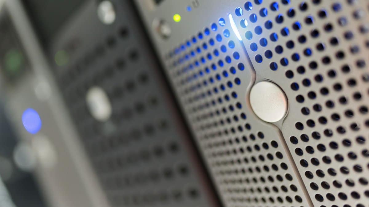 Focused detail of a modern server rack with blue LED indicators in a data center.