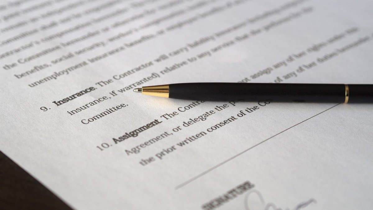 Close-up image of a business contract and pen, signed and ready for agreement.