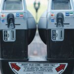 Photo of two parking meters in Orlando showing coin and card payment options on a brick road.