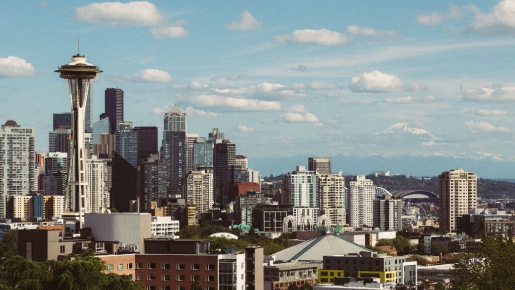 Breathtaking view of Seattle's iconic skyline with the Space Needle and Mount Rainier in the background.