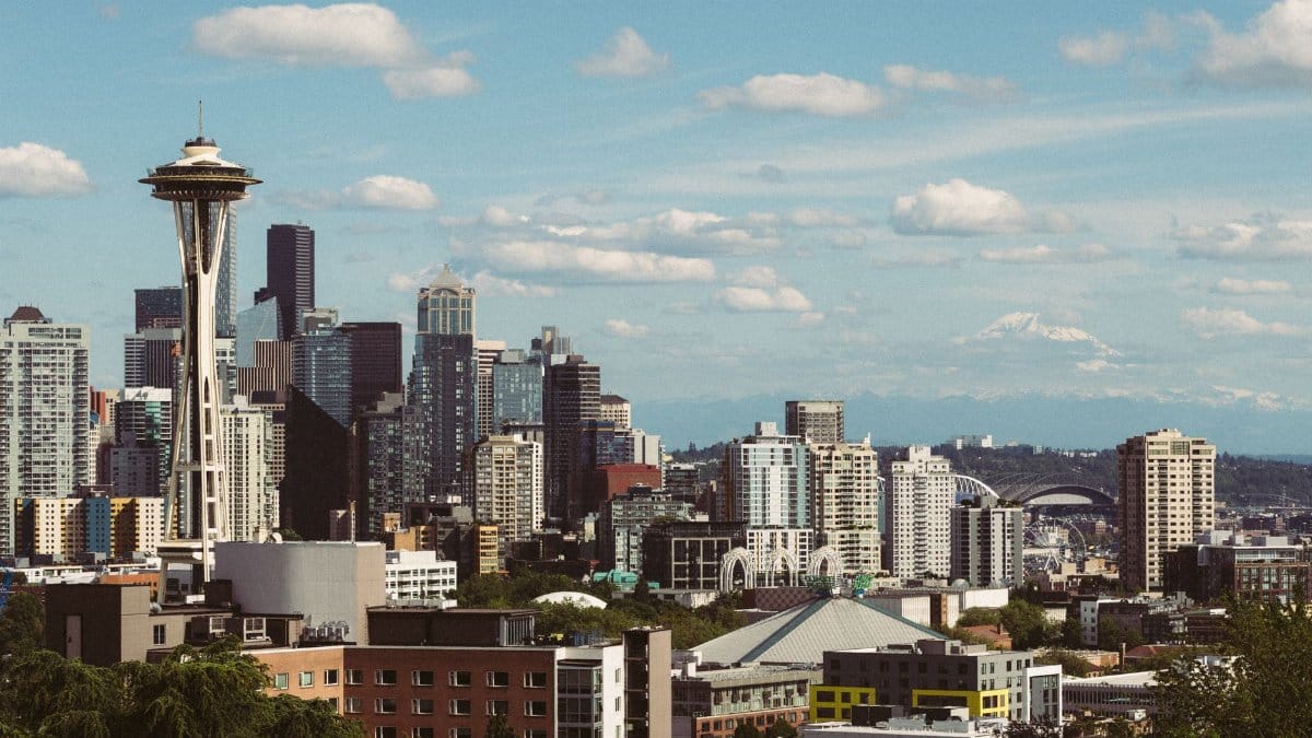 Breathtaking view of Seattle's iconic skyline with the Space Needle and Mount Rainier in the background.