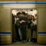 Busy commuters inside a subway train at Suminoekoen Station, Japan. Ideal for urban transport themes.