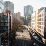 Aerial view of a Seattle city street with modern architecture and monorail tracks.