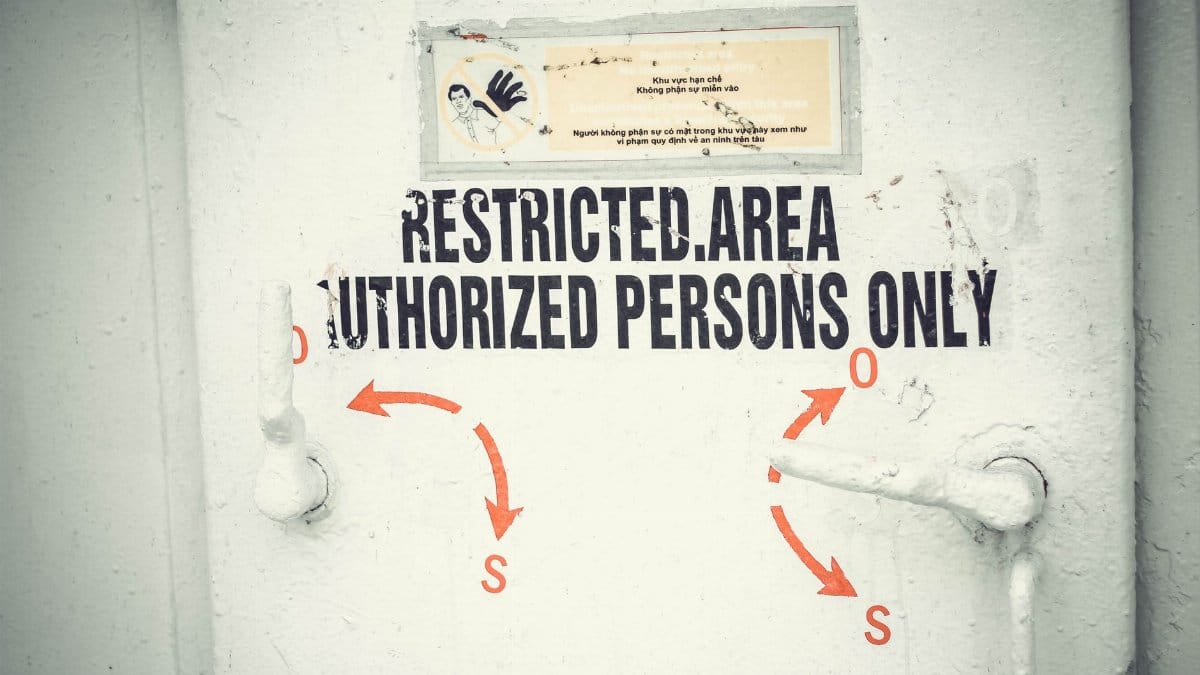 Close-up of a restricted area door with signage emphasizing authorized access only.