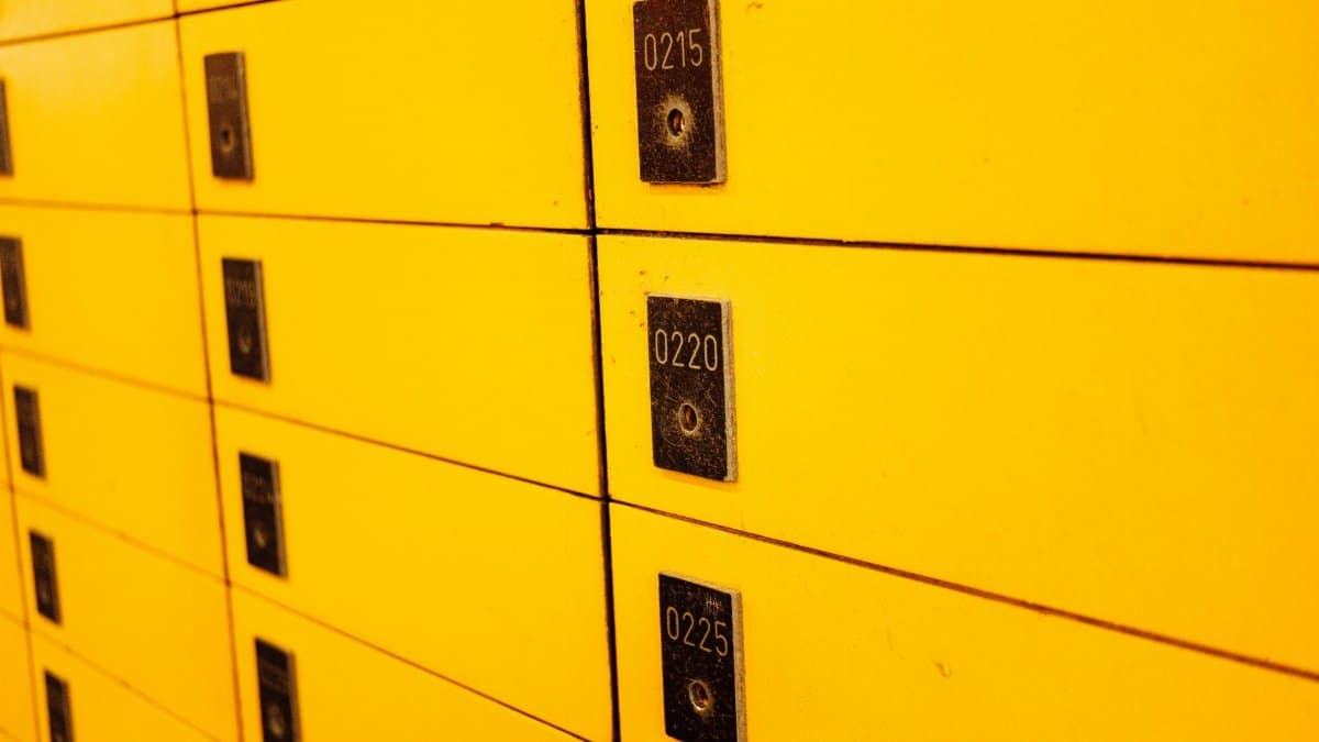 Close-up view of yellow lockers with numbered plaques, ideal for storage or security themes.