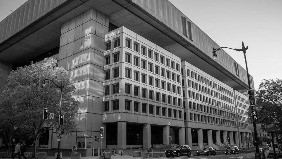 Black and white image of the FBI Headquarters in Washington, D.C. under a clear sky.
