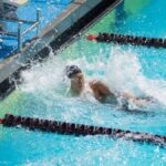 Swimmers compete in an exciting outdoor swimming race, capturing intensity and athleticism.