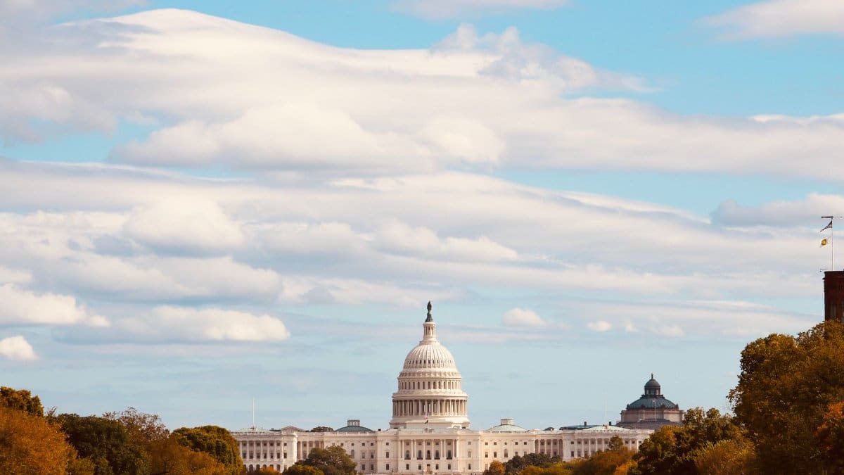 The United States Capitol with a clear blue sky and fall foliage, Washington D.C.