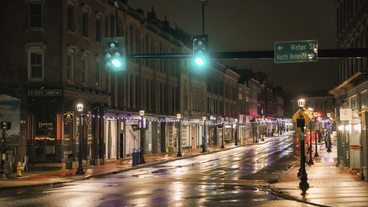 A quiet, illuminated street scene in downtown Norwalk after rain.