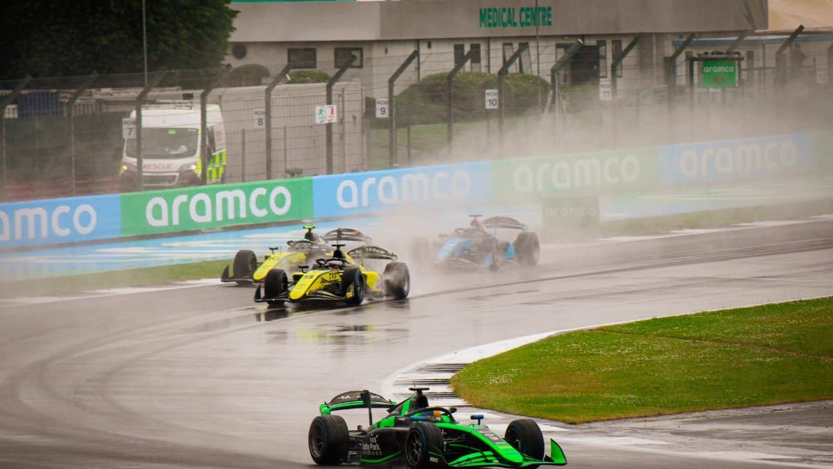 Exciting Formula 1 race on a wet track showcasing high-speed dynamics.