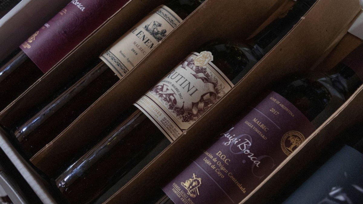 A selection of fine Argentinian wines in a box featuring various labels and vintages, perfect for wine enthusiasts.