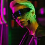 Stylish woman in cyberpunk glasses with neon lights and futuristic makeup.