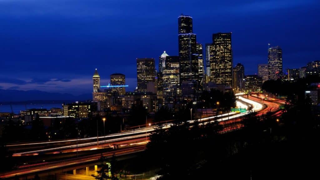 Stunning night view of Seattle's skyline with vibrant light trails and city lights creating a dynamic cityscape.