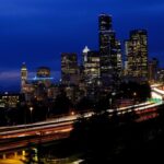 Stunning night view of Seattle's skyline with vibrant light trails and city lights creating a dynamic cityscape.