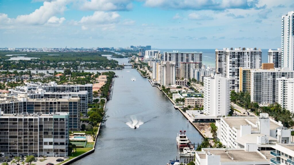 Stunning aerial view of Hollywood, Florida's coastal cityscape with high-rise buildings and a serene waterway.