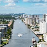 Stunning aerial view of Hollywood, Florida's coastal cityscape with high-rise buildings and a serene waterway.