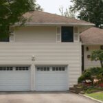 Charming suburban house featuring a double garage and lush garden, ideal for real estate listings.