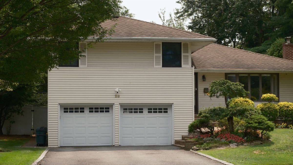 Charming suburban house featuring a double garage and lush garden, ideal for real estate listings.