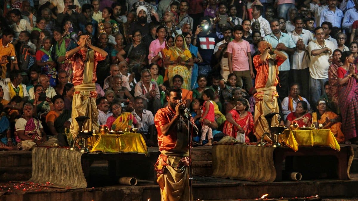 A vibrant scene of a traditional Indian cultural performance with a large audience.