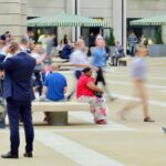 People in motion at Paternoster Square, capturing vibrant city life near St. Paul's Cathedral, London.