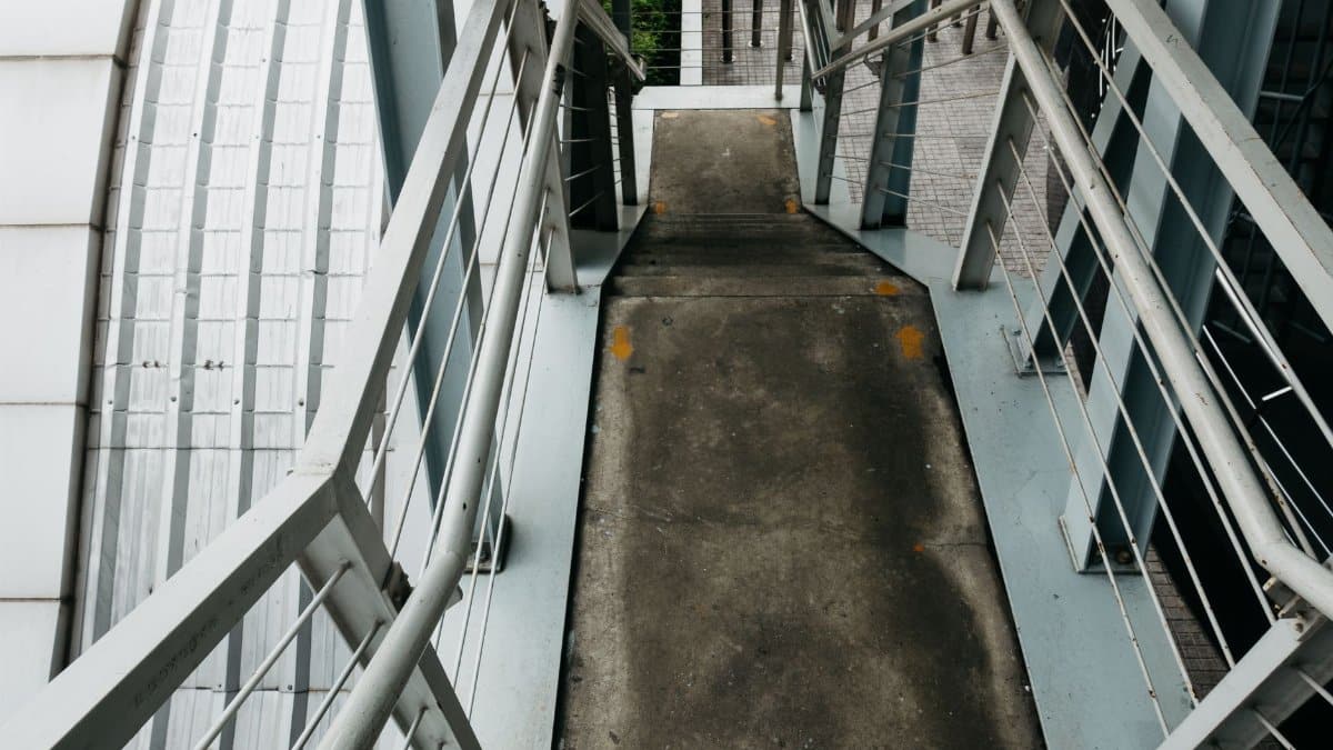 Explore modern urban architecture with this perspective of an industrial staircase and steel railings.