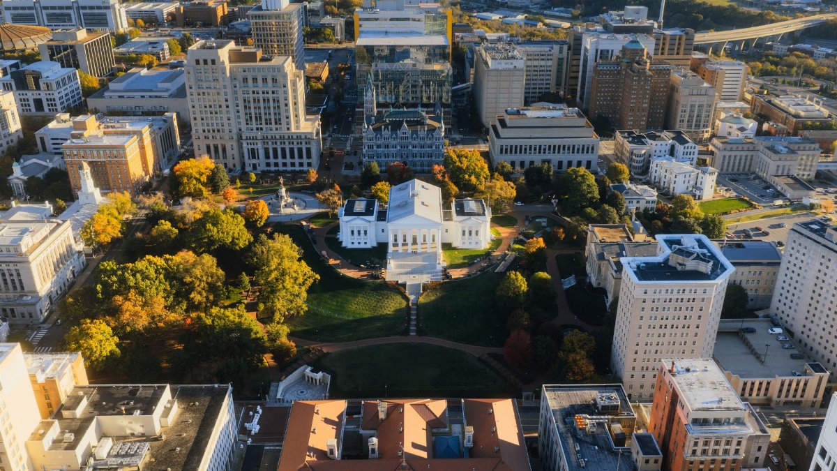 Stunning aerial view of the Virginia State Capitol surrounded by vibrant autumn foliage in downtown Richmond.