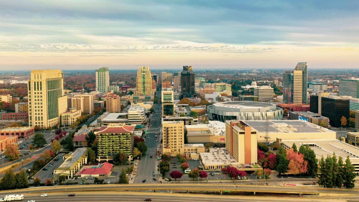 Stunning aerial view of downtown Sacramento skyline with landmarks and autumn foliage.