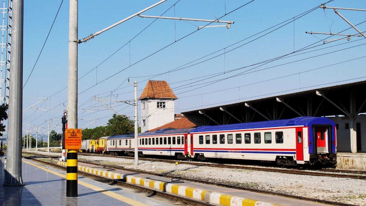 A vibrant train at Balıkesir station, capturing the essence of Turkish rail travel.