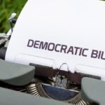 Close-up of a vintage typewriter printing a democratic bill, symbolizing government and legislative concepts.
