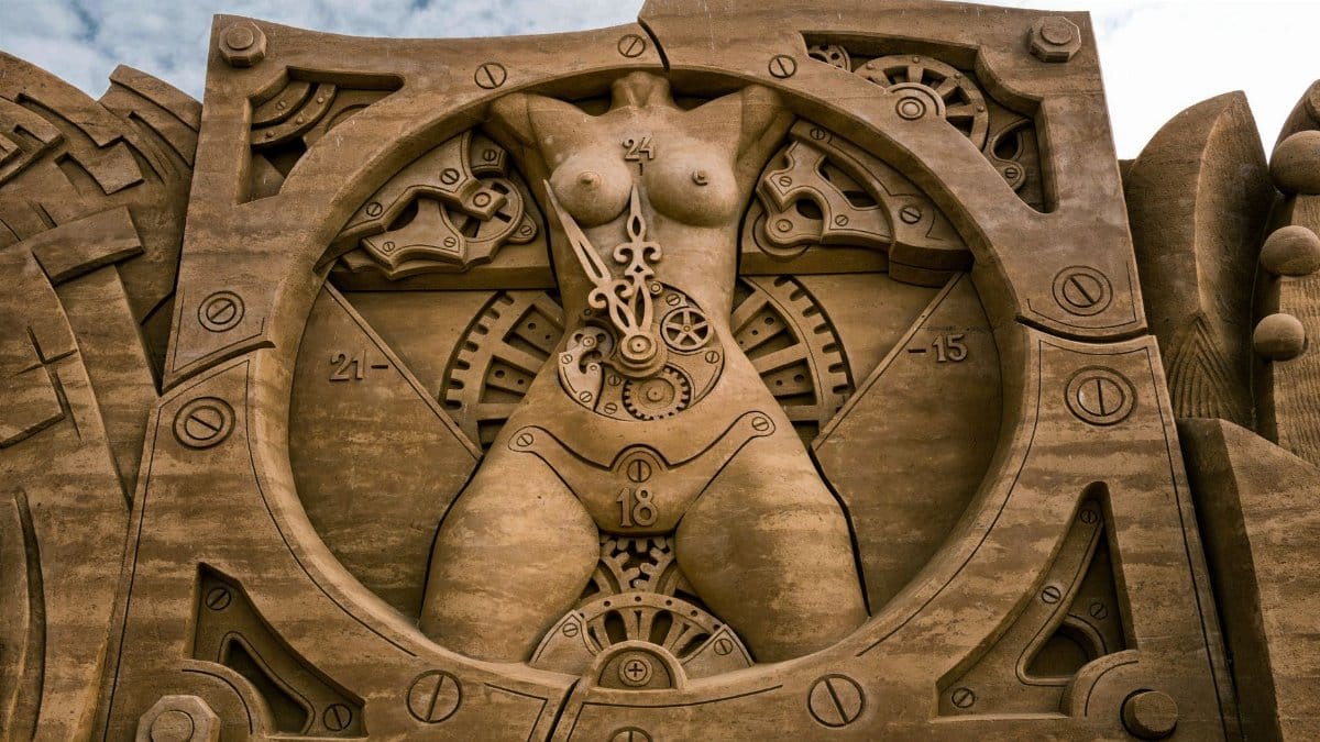Detailed sand sculpture depicting a clockwork theme with human form elements.