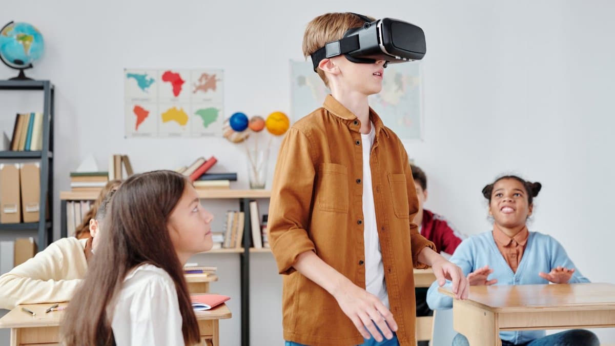 Children engaged with virtual reality headsets in a vibrant classroom setting, exploring immersive technology.
