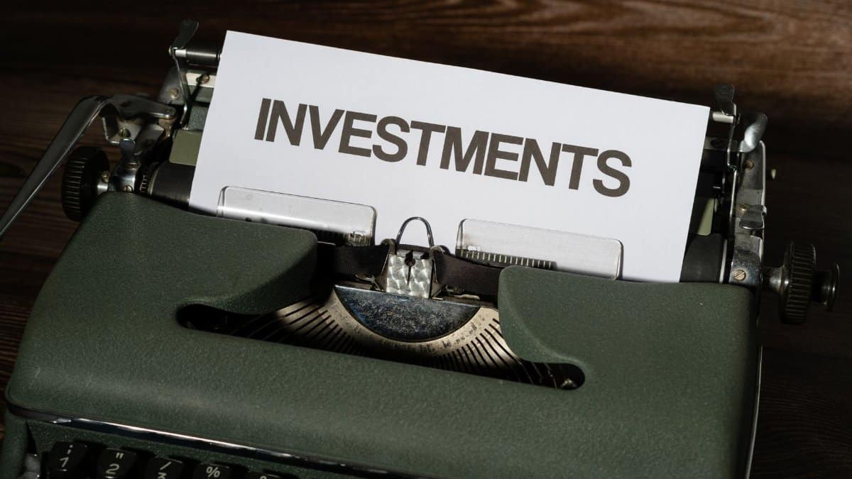 Close-up of a vintage typewriter with a paper labeled 'INVESTMENTS'.
