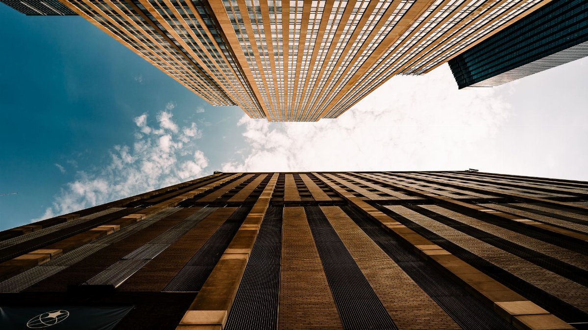 Dramatic upward view of skyscrapers against a blue sky in Minneapolis, Minnesota.