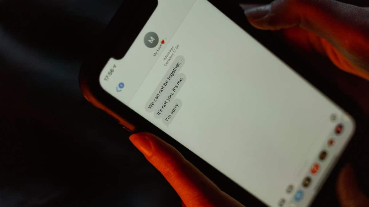 A close-up view of a text message on a smartphone screen displaying a breakup message.
