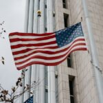 Low angle of American flag waving in front of a government building in Anaheim, CA.