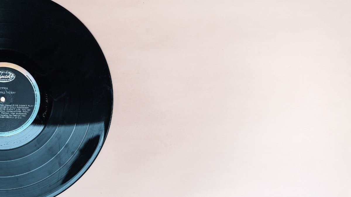 Close-up of a classic vinyl record with copyspace on a beige backdrop.
