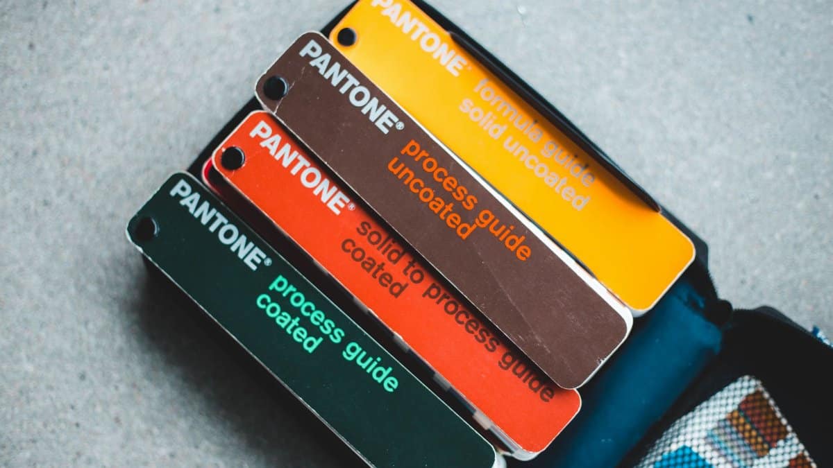 Top view of Pantone color guides showcasing vibrant shades for creative design projects.