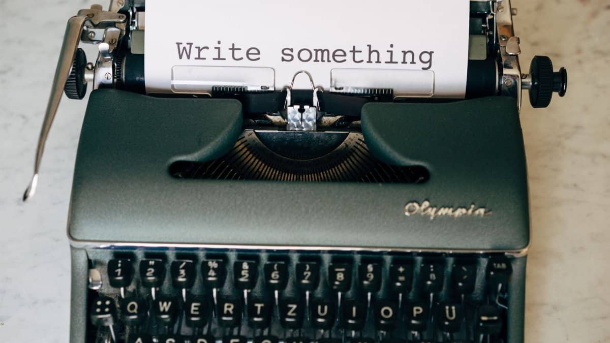 Classic typewriter displaying 'Write something' on paper. Perfect for creative inspiration.