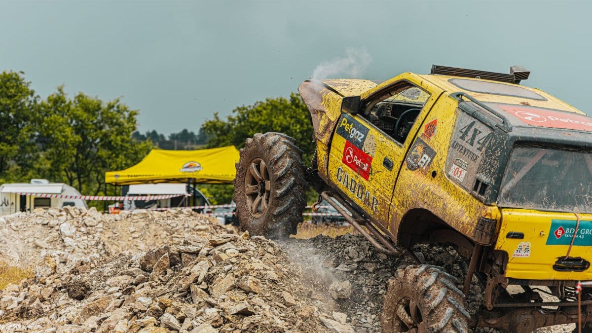 Dynamic offroad car race conquering rocky terrain with adrenaline and excitement.