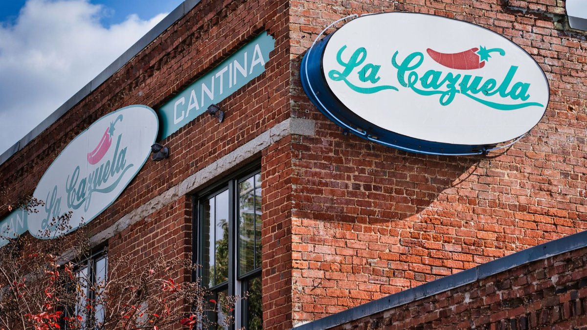 Redbrick exterior of La Cazuela cantina in Lawrenceville, GA, showcasing a vibrant urban scene.