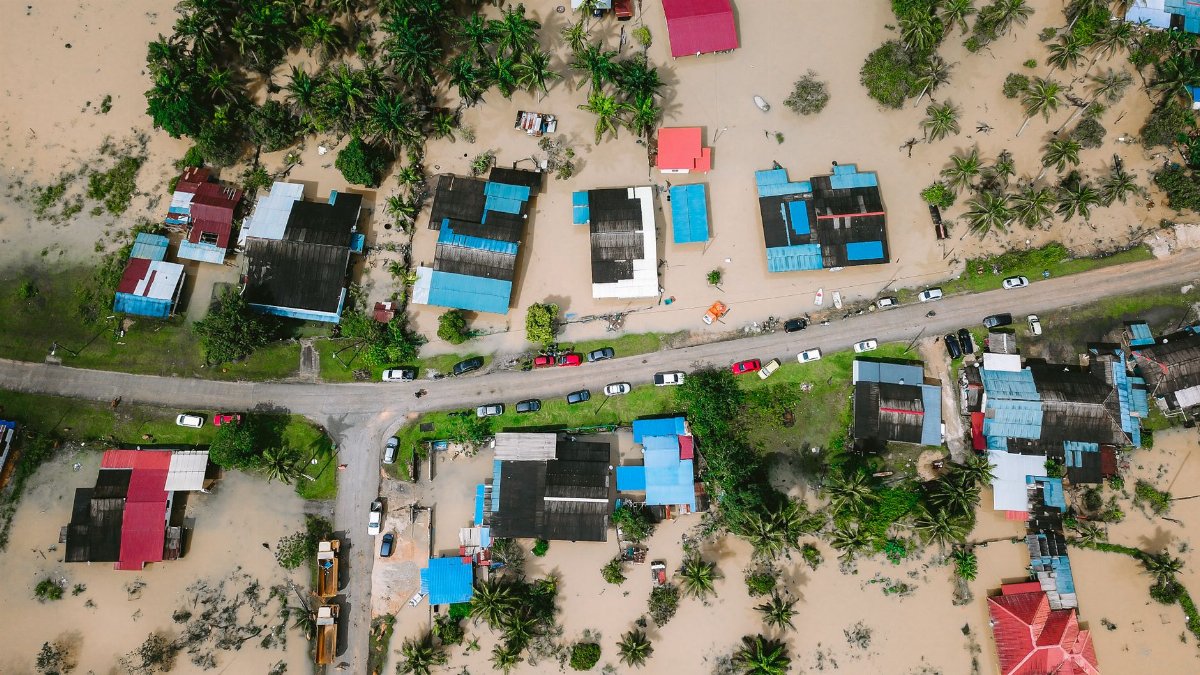 Aerial shot showing flooded houses in Kijal, Terengganu, Malaysia, highlighting the impact of natural disasters.