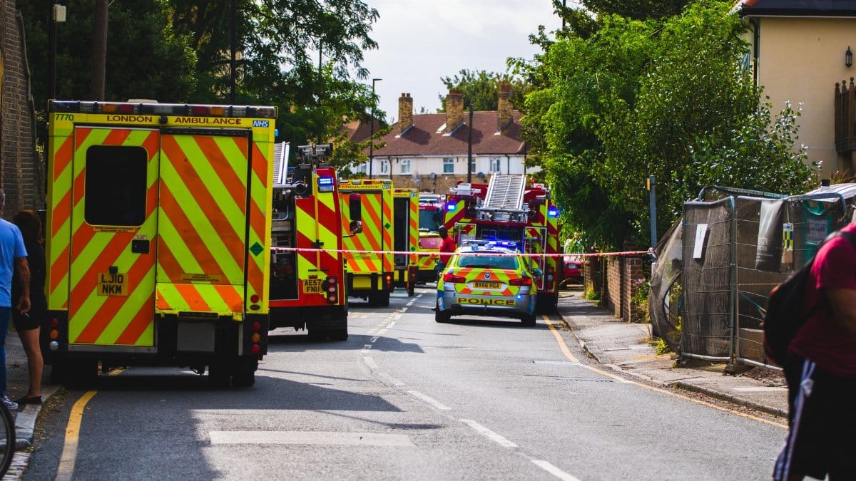 Emergency vehicles respond to an incident on a residential street, road closed.