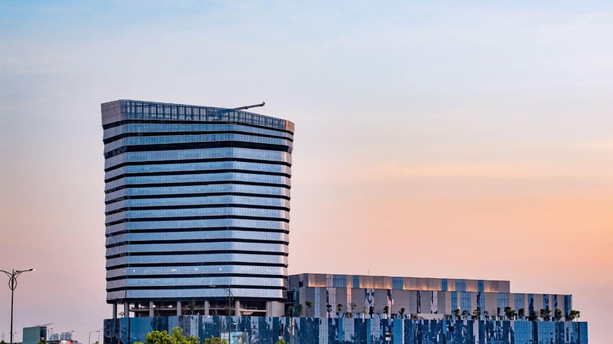 Elegant modern skyscraper in Ho Chi Minh City at sunset with a pastel sky.