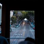 A scenic view of San Francisco streets from inside a moving cable car, highlighting urban transportation.