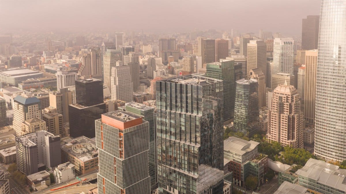 Stunning aerial view of San Francisco's modern skyline showcasing prominent skyscrapers on a foggy day.