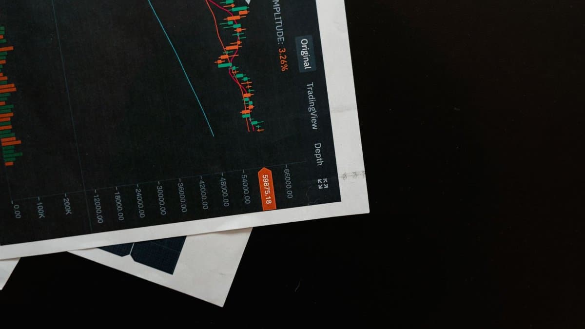 Detailed close-up of a financial chart on a black surface, showing stock market analysis.