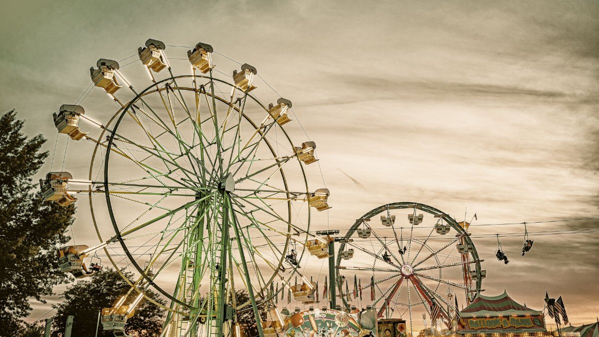 A classic Ferris wheel at an outdoor carnival during twilight, capturing nostalgic vibes.